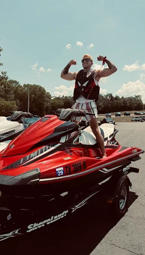 Rider flexing on a red Sea-Doo jet ski rental at Old Hickory Lake