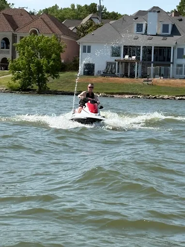 Rider on a Yamaha WaveRunner cruising past lakefront homes on Old Hickory Lake